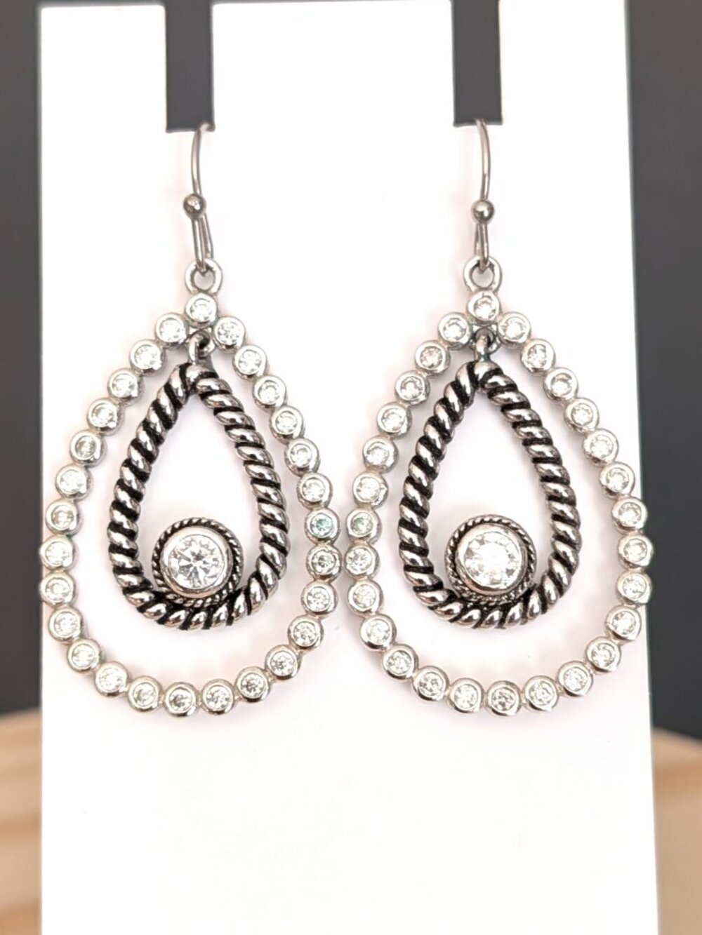 Double teardrop shaped silver earrings with cz accents